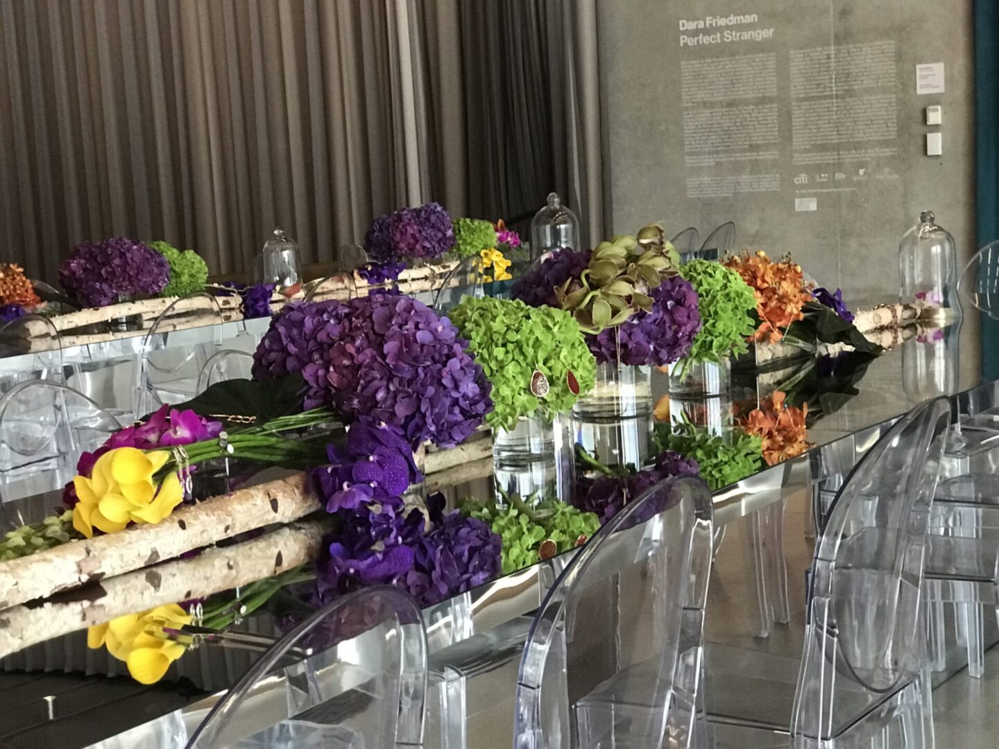 A long table with flowers and glasses on it
